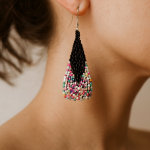 Pair of handcrafted teardrop fringe earrings with silver ear hooks. The top section is solid black beadwork, transitioning sharply to a vibrant mix of multicolored square seed beads (pink, yellow, blue, green, and orange) at the bottom.