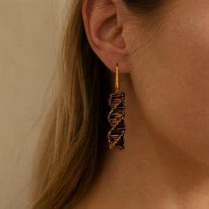 A pair of gold and bronze spiral beaded earrings with elongated metallic beads and hook-style ear wires.